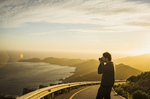 USA, California, San Francisco, California, Silhouette of man photographing coastline at sunset