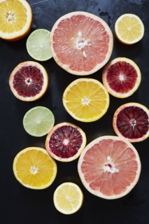 Halved fruits on black background