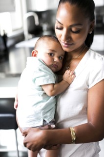 Portrait of mother holding baby boy (2-5 months)