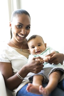 Portrait of mother holding baby boy (2-5 months)