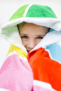 Portrait of smiling girl (4-5) in colorful towel