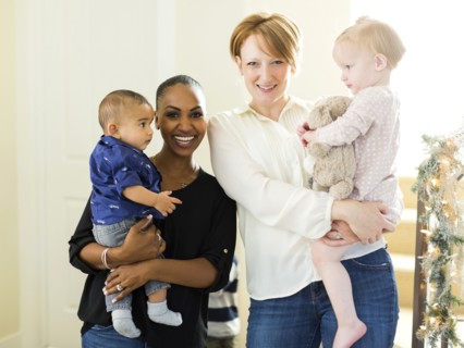Portrait of mothers holding children (2-5 months, 12-17months)