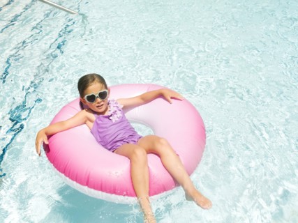Girl (4-5) relaxing in inflatable ring