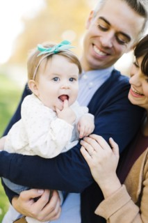 Parents holding daughter (12-17 months)