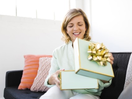 Mature woman opening gift