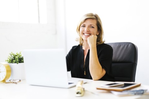 Portrait of Mature woman in office with hand on chin