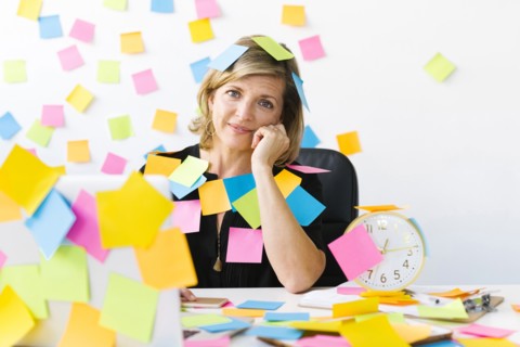 Portrait of Mature woman at office covered with adhesive notes
