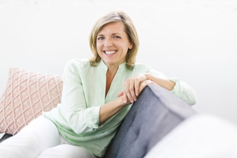 Portrait of woman sitting on sofa