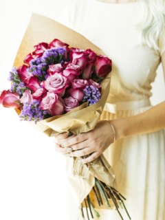 Woman holding bouquet with roses