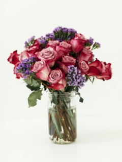 Jar with bouquet of red roses