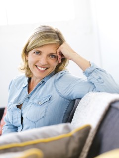 Portrait of woman sitting on sofa