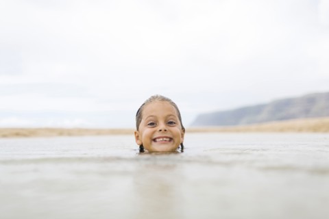 Girl (6-7) swimming in sea