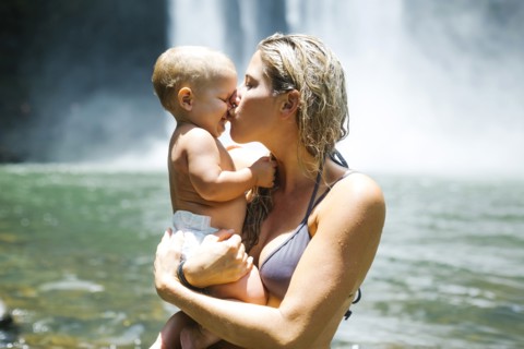 Mother kissing baby (18-23 months) with love
