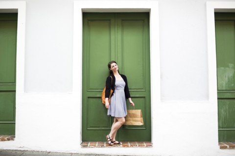 Puerto Rico, San Juan, Woman with shopping bag walking city streets