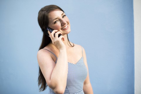 Cheerful woman during phone conversation