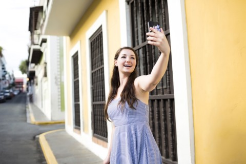 Puerto Rico, San Juan, Beautiful woman doing selfie on city street