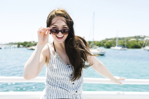 USA, Virgin Islands, Saint Thomas, Woman peeking over sunglasses