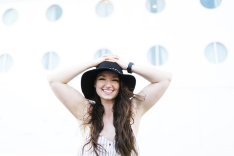 Cheerful woman in black hat