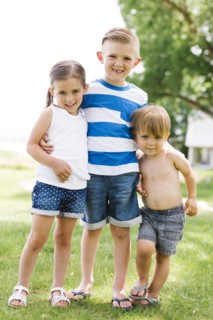 Siblings (2-3, 4-5, 6-7) embracing in park