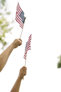 American flags holds by boy (6-7) and girl (4-5)