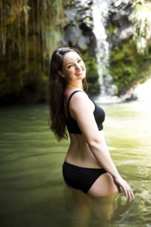 Caribbean Islands, Saint Lucia, Woman standing in water by waterfall