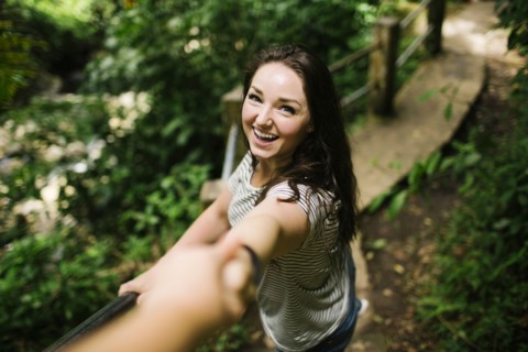 Caribbean Islands, Saint Lucia, Smiling women standing on path, holding person's hand and looking at camera
