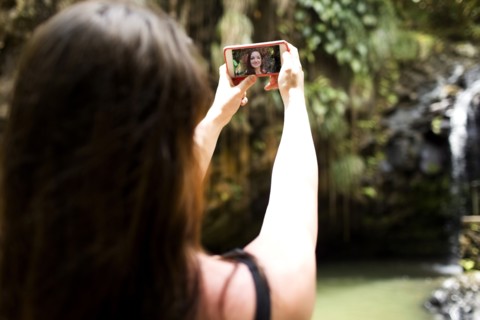 Saint Lucia, Woman taking selfie in front of waterfalls