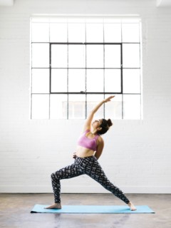 Woman practicing yoga on exercise mat