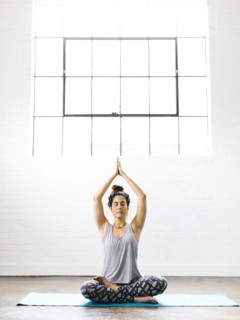 Woman meditating on exercise mat