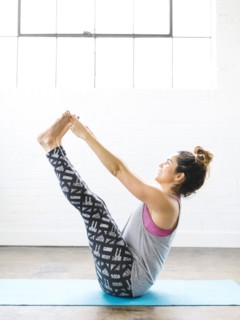 Woman practicing yoga on exercise mat