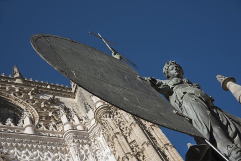 Spain, Seville, Facade of Cathedral of Seville with statue