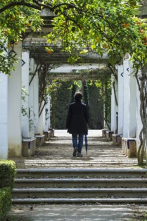 Spain, Seville, Maria Luisa Park, Woman walking through park