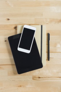 Directly above view of smart phone and personal organizers on wooden desk