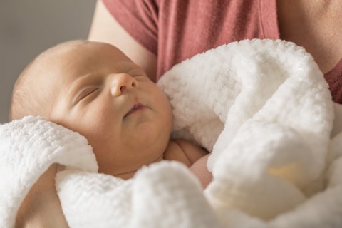 Baby boy (0-1 months) in mothers arms