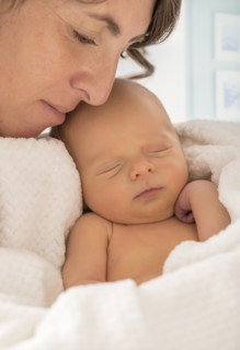 Mother embracing newborn son (0-1 month)