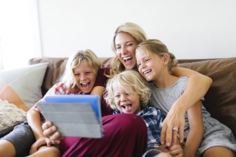 Mother and children (4-5, 6-7, 8-9) taking selfie with digital tablet