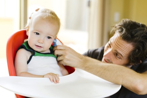 Father measuring son's (12-17 months) temperature