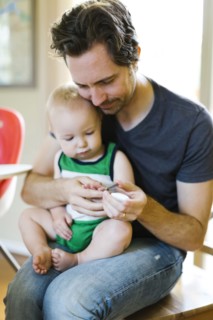 Father clipping nails to son (12-17 months)