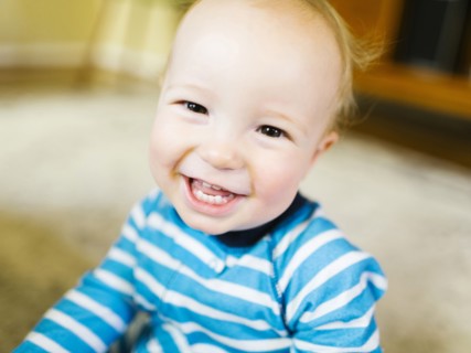 Portrait of baby boy (12-17 months) smiling