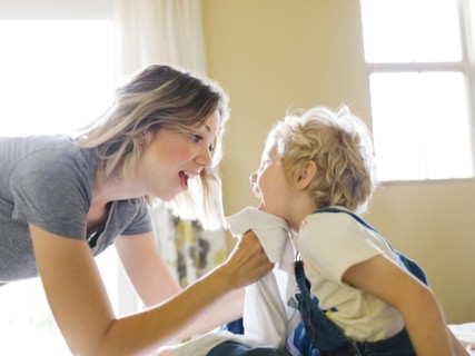 Mother cleaning son's face (4-5) with towel