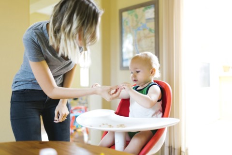 Mother feeding son (12-17 months) with breakfast cereals