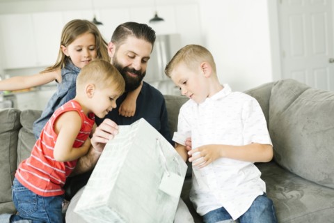 Family with three children (2-3, 6-7) celebrating fathers day