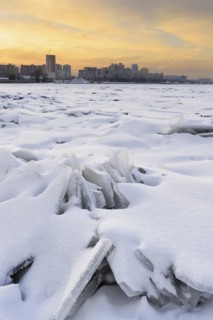 Ukraine, Dnepropetrovsk region, Dnepropetrovsk city, Frozen river with distant cityscape