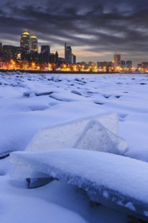 Ukraine, Dnepropetrovsk region, Dnepropetrovsk city, Frozen river with distant city skyline at dusk