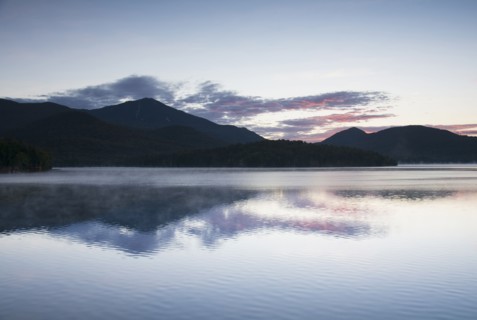 USA, New York, Silhouette of mountains with Lake Placid in foreground at sunrise
