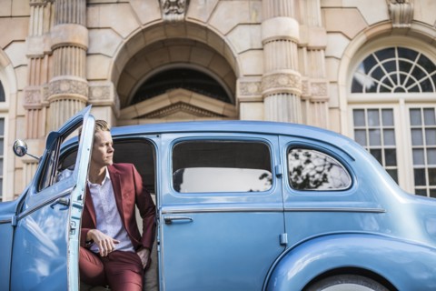 Elegant man sitting in vintage car