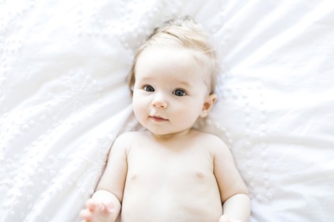 Portrait of baby girl (6-11 Months) smiling, directly above
