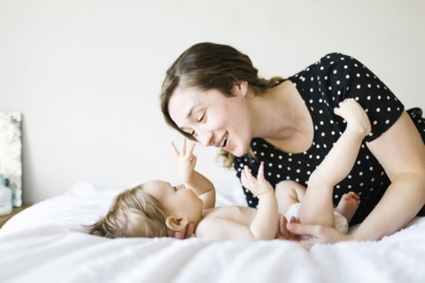 Baby girl (6-11 Months) playing with mother