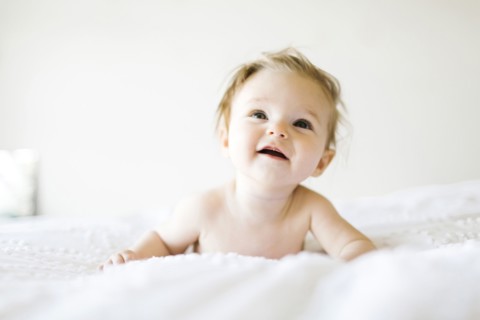 Baby girl (6-11 months) playing in bedroom