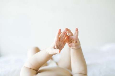 Baby girl (6-11 months) playing in bedroom